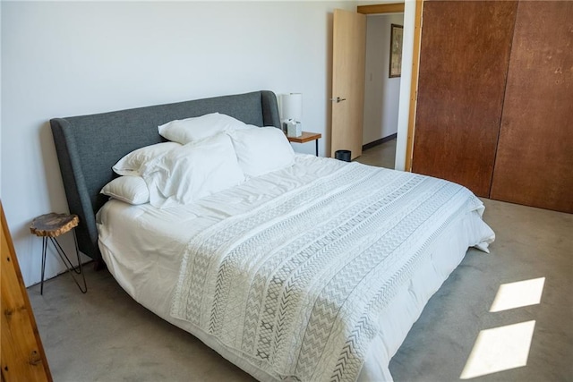 bedroom featuring a closet and light colored carpet