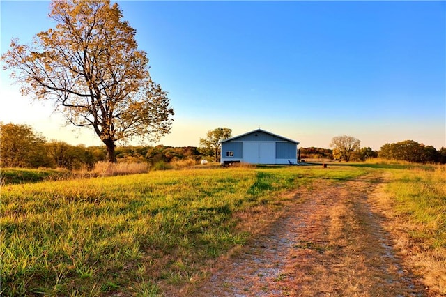 yard at dusk with a rural view