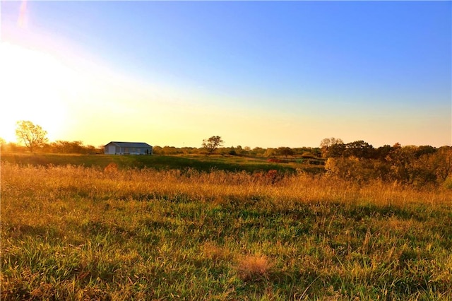 nature at dusk featuring a rural view