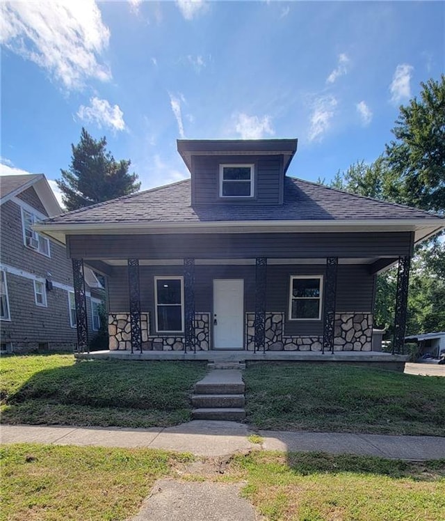 bungalow-style house with a porch and a front lawn