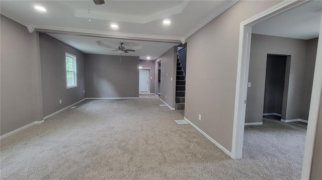 spare room featuring carpet flooring, crown molding, and ceiling fan