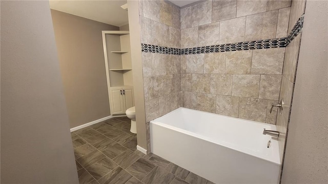 bathroom featuring toilet, tiled shower / bath combo, and tile patterned flooring