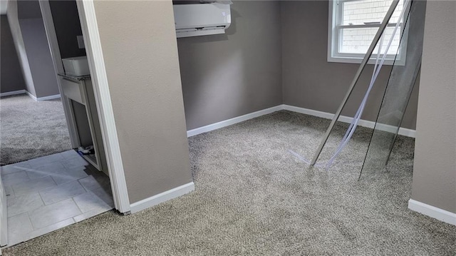 spare room with carpet flooring and a wall unit AC