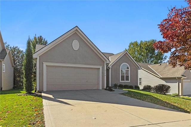 view of front of home with a front yard and a garage