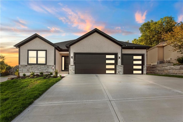 view of front of property with a lawn and a garage