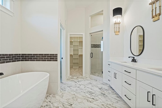 bathroom with vanity and separate shower and tub