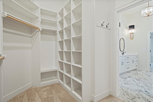 walk in closet featuring light colored carpet