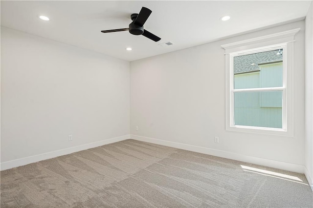 carpeted spare room with ceiling fan