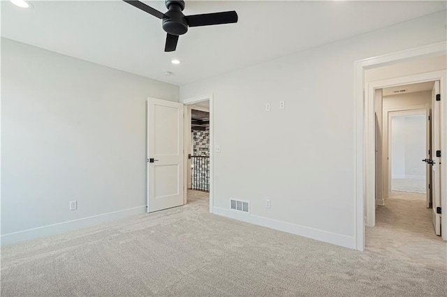 unfurnished bedroom with light carpet and ceiling fan