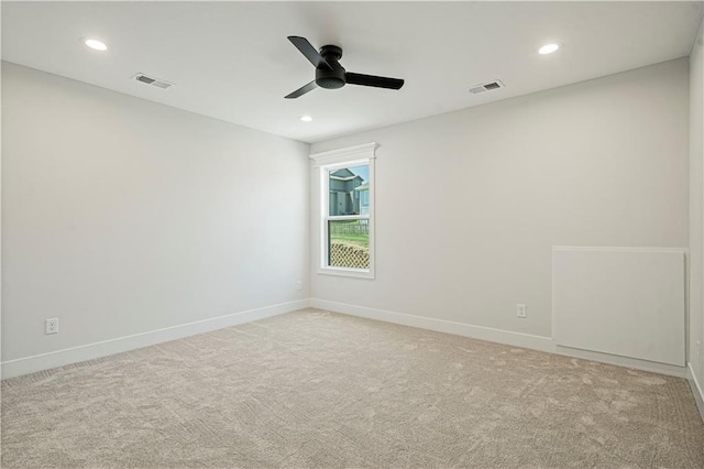 empty room with ceiling fan and light colored carpet