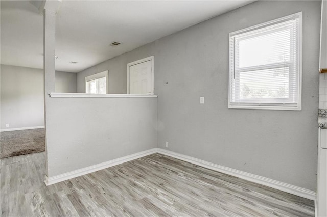 spare room with light hardwood / wood-style flooring