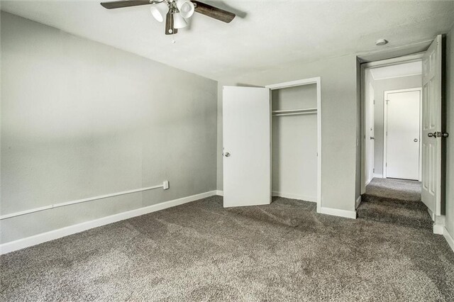 unfurnished bedroom featuring ceiling fan, a closet, and dark carpet