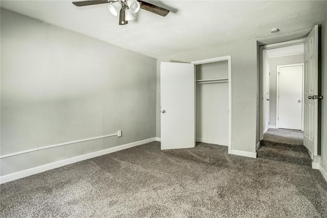 unfurnished bedroom with ceiling fan, dark carpet, and a closet