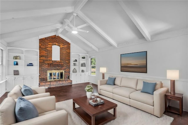 22750 Switzer Rd, Bucyrus, KS 66013 - living area with ceiling fan, wood finished floors, vaulted ceiling with beams, a brick fireplace, and built in shelves