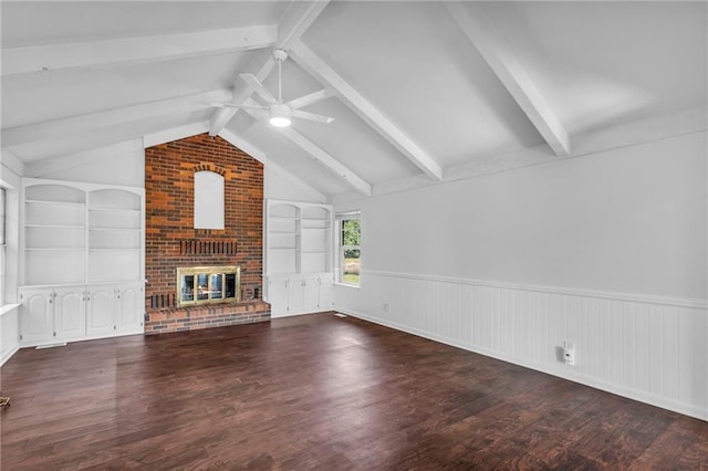 22750 Switzer Rd, Bucyrus, KS 66013 - unfurnished living room featuring lofted ceiling with beams, a fireplace, wood finished floors, a ceiling fan, and built in features
