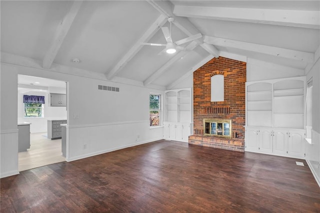 22750 Switzer Rd, Bucyrus, KS 66013 - unfurnished living room with built in features, vaulted ceiling with beams, a fireplace, visible vents, and wood finished floors