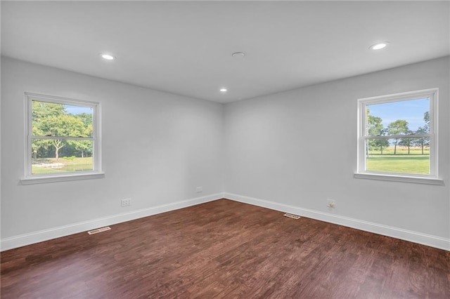 22750 Switzer Rd, Bucyrus, KS 66013 - unfurnished room with dark wood-style flooring, recessed lighting, visible vents, and baseboards