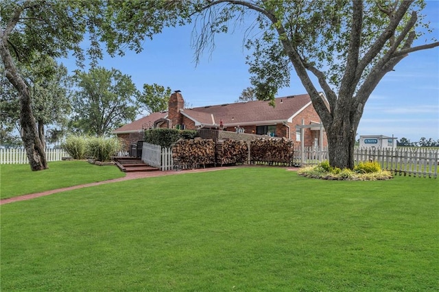 22750 Switzer Rd, Bucyrus, KS 66013 - view of front facade with a front yard, brick siding, and fence