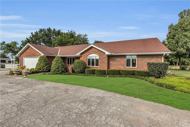 22750 Switzer Rd, Bucyrus, KS 66013 - single story home with a garage, brick siding, driveway, and a front lawn