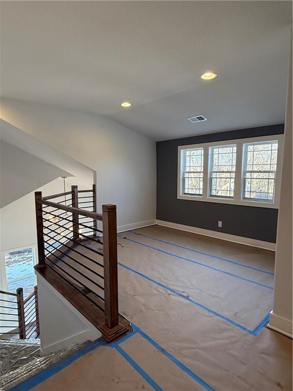 unfurnished room featuring baseboards, visible vents, and recessed lighting