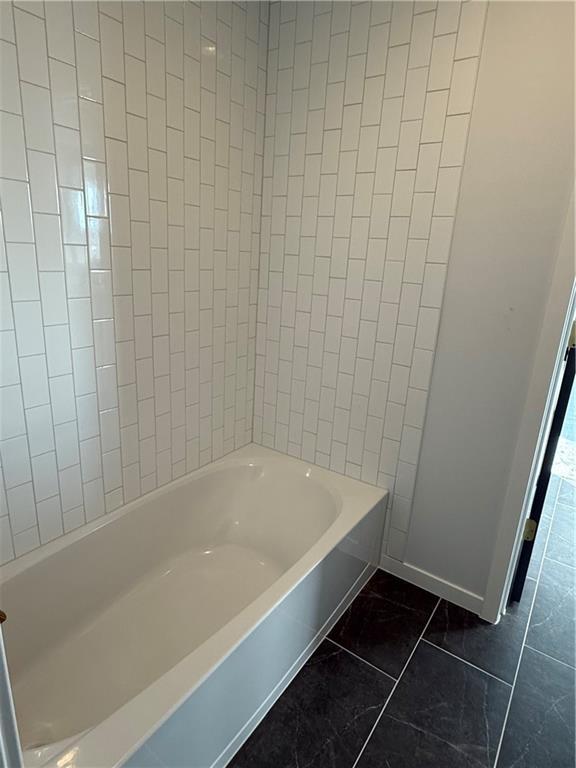 bathroom with tile patterned floors and shower / bathing tub combination