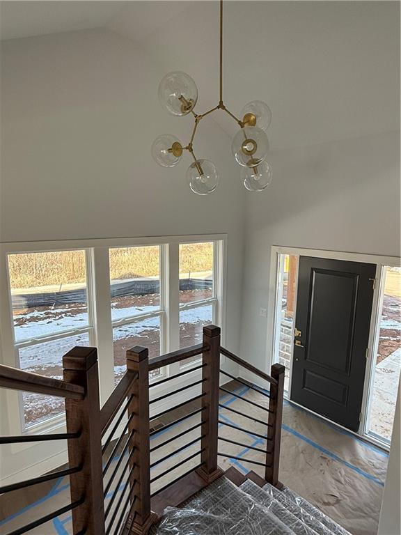 foyer featuring high vaulted ceiling and a notable chandelier