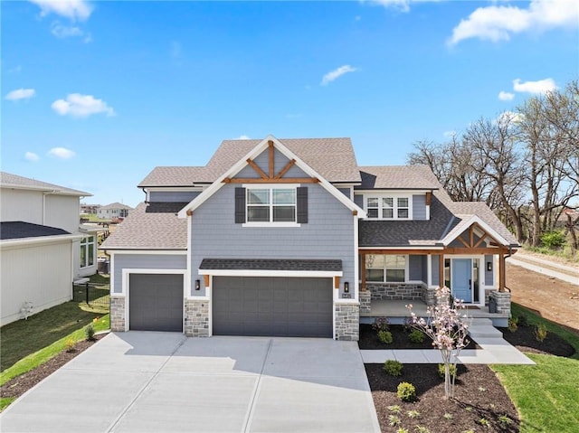 18452 Windsor St, Overland Park, KS 66085 - craftsman-style home featuring driveway, stone siding, a shingled roof, a porch, and a garage