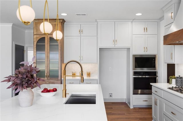 18452 Windsor St, Overland Park, KS 66085 - kitchen with a sink, pendant lighting, stainless steel appliances, wall chimney exhaust hood, and visible vents
