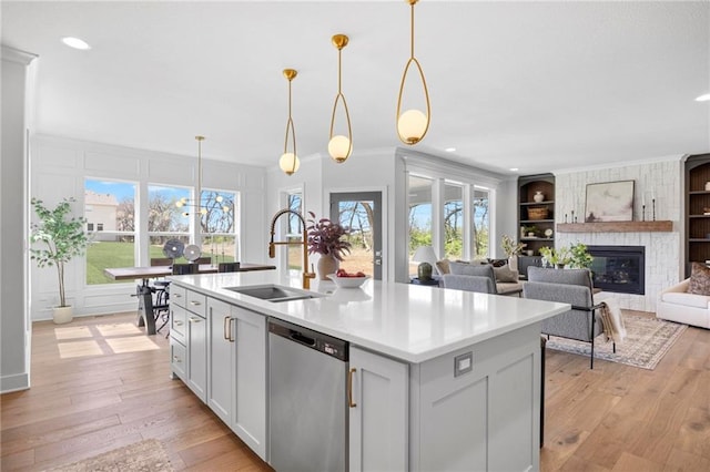 18452 Windsor St, Overland Park, KS 66085 - kitchen with a sink, built in features, light wood-style floors, dishwasher, and light countertops