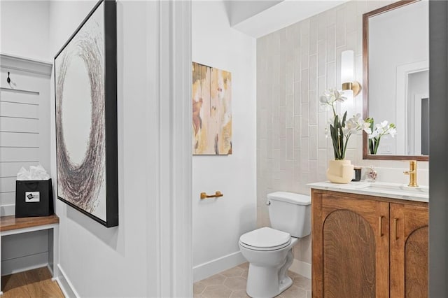 18452 Windsor St, Overland Park, KS 66085 - bathroom with baseboards, vanity, and toilet
