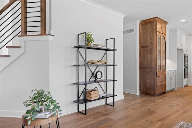 18452 Windsor St, Overland Park, KS 66085 - interior space with light wood-style flooring, baseboards, visible vents, recessed lighting, and stairway