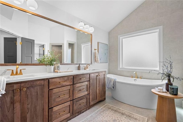 18452 Windsor St, Overland Park, KS 66085 - bathroom featuring lofted ceiling, tile patterned floors, a freestanding bath, double vanity, and a sink