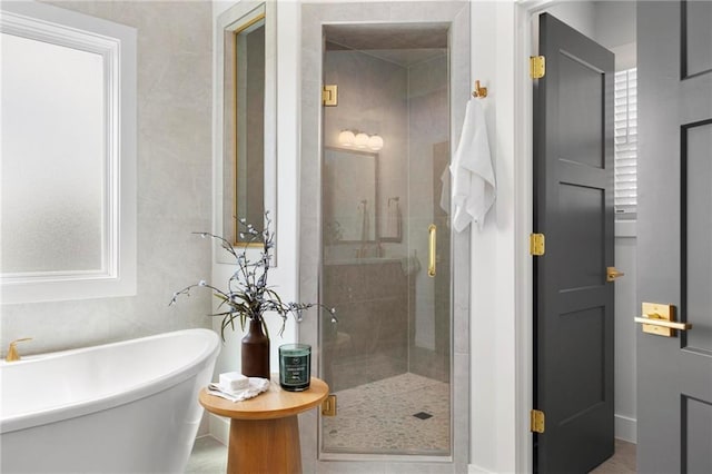 18452 Windsor St, Overland Park, KS 66085 - bathroom featuring a shower stall and a freestanding bath