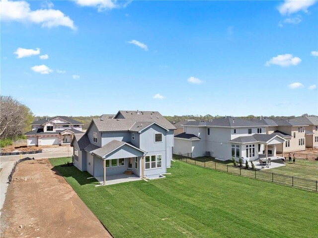 18452 Windsor St, Overland Park, KS 66085 - back of property with a lawn, fence, and a residential view