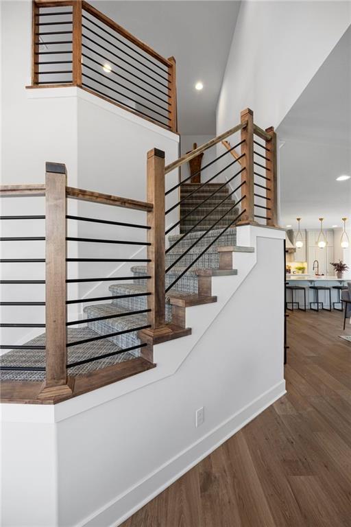 18452 Windsor St, Overland Park, KS 66085 - stairway with baseboards, wood finished floors, and recessed lighting