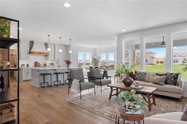 18452 Windsor St, Overland Park, KS 66085 - living room with recessed lighting, hardwood / wood-style floors, and crown molding