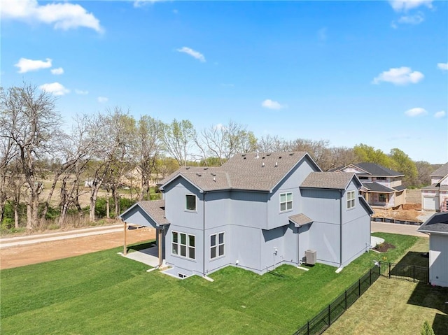 18452 Windsor St, Overland Park, KS 66085 - rear view of property with fence, a shingled roof, a yard, and central air condition unit