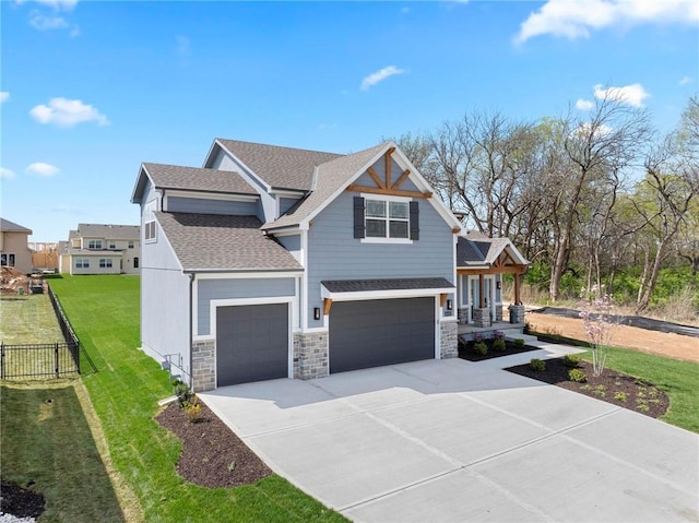 18452 Windsor St, Overland Park, KS 66085 - view of front facade with concrete driveway, stone siding, a shingled roof, fence, and a garage
