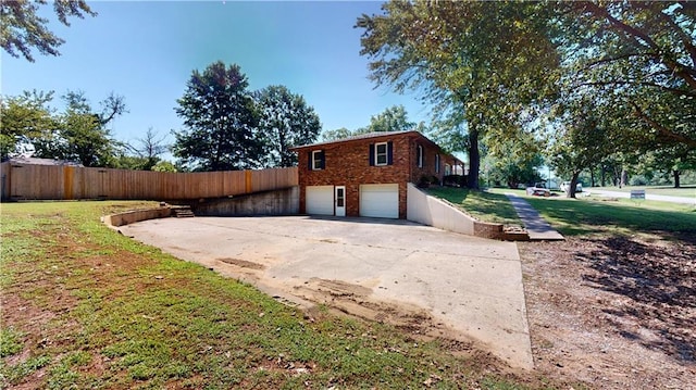 view of side of home with a yard and a garage