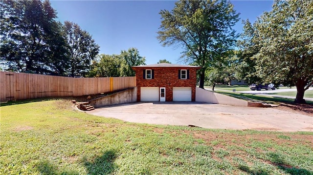 exterior space featuring a garage and a lawn