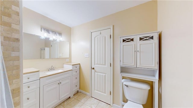 bathroom featuring toilet, vanity, and tile patterned flooring