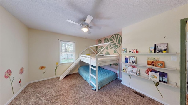 carpeted bedroom with a textured ceiling and ceiling fan