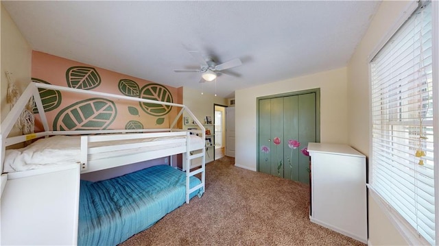 bedroom featuring light carpet, ceiling fan, and a closet