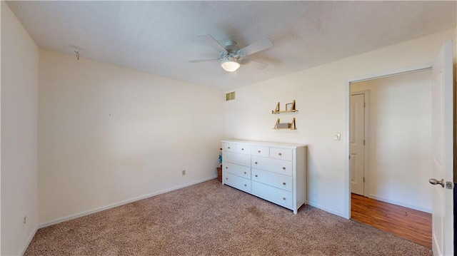 unfurnished bedroom with light carpet and ceiling fan