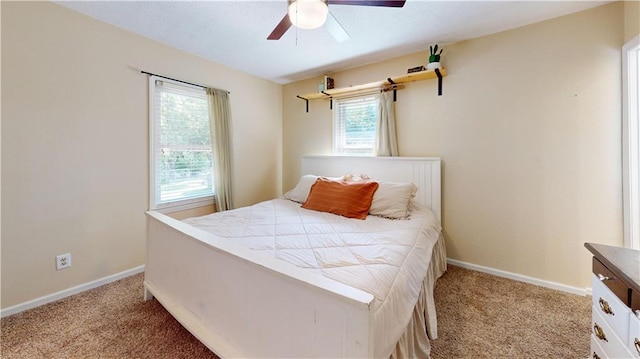 bedroom with ceiling fan and light carpet