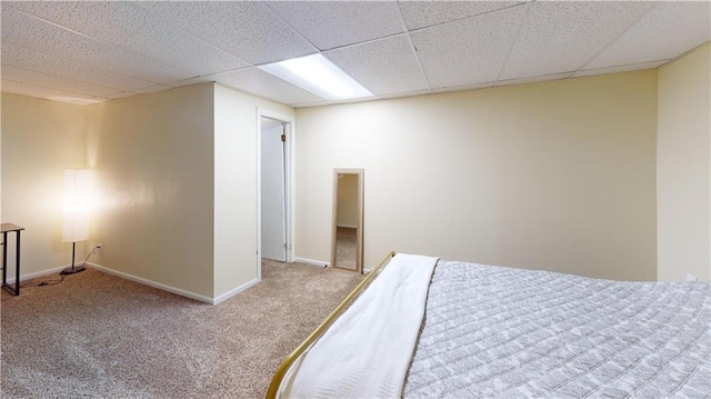 carpeted bedroom featuring a paneled ceiling