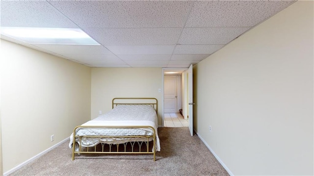 unfurnished bedroom featuring carpet floors and a paneled ceiling