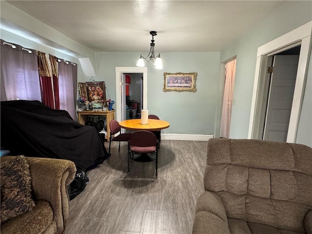 sitting room with an inviting chandelier, wood finished floors, and baseboards