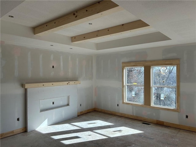 interior space with beamed ceiling, baseboards, and visible vents