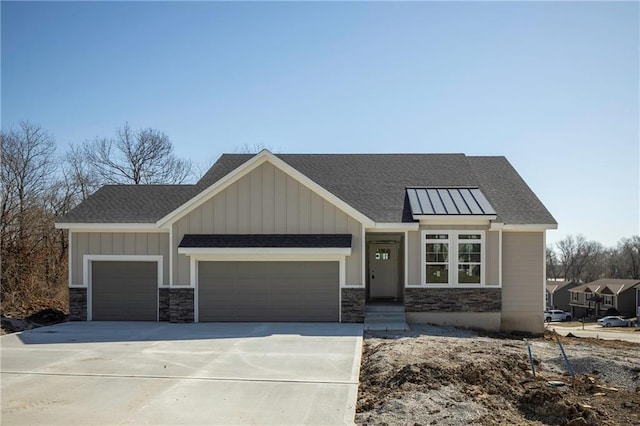 view of front of house with driveway, stone siding, board and batten siding, an attached garage, and a shingled roof